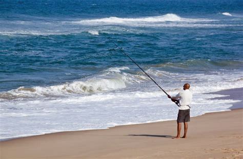 Fisherman Fishing Off Blue Lagoon Beach in Early Morning Editorial ...