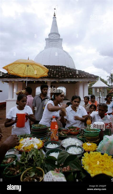 Sri Lankan tsunami survivors make offerings at a temple in memory of tsunami victims on the ...