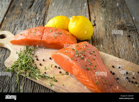 Salmon on a Cutting Board with Lemon, Salt and Pepper Stock Photo - Alamy