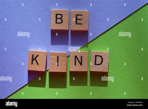 Be Kind, words in 3d wooden alphabet letters on a mauve and green background Stock Photo - Alamy