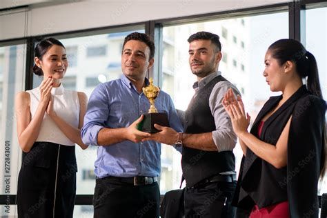 winning business team with a gold trophy award . successful . Stock Photo | Adobe Stock