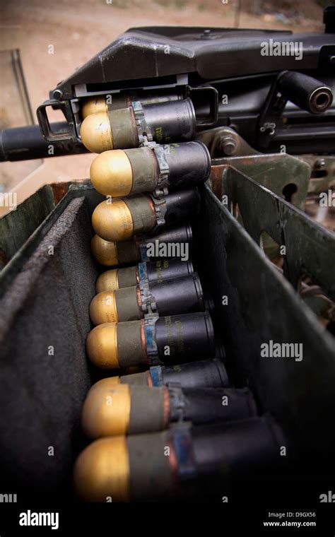 Linked 40mm rounds feed into a Mark 19 grenade launcher Stock Photo - Alamy