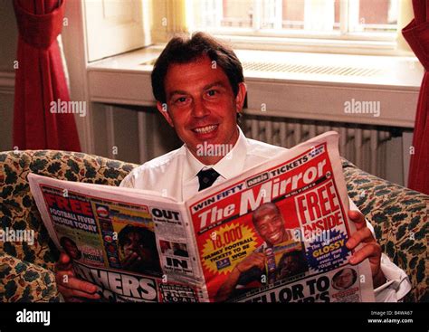 Tony Blair Prime Minister at Number 10 1997 reading a copy of The Mirror newspaper Stock Photo ...