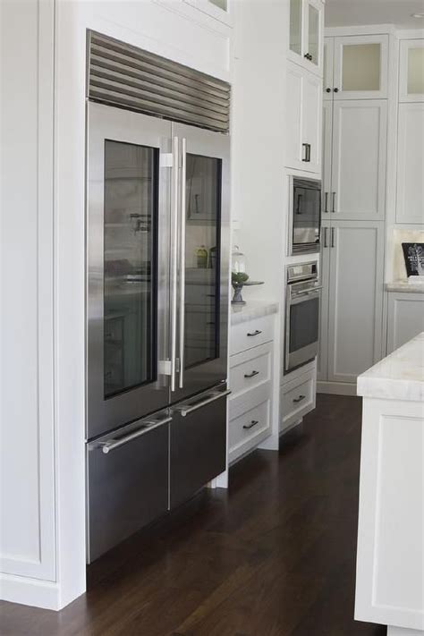 Exceptional kitchen features an industrial style refrigerator with two ...