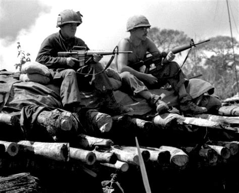 Soldiers of the US Army 4th Infantry Division sit on top of a bunker at their fire base near ...