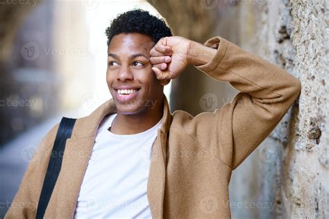 Happy young black man smiling in urban background. 5890017 Stock Photo at Vecteezy