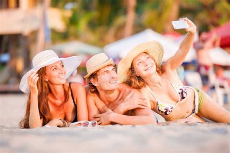 Group of Happy Young People Lying on Wite Beach Stock Image - Image of shore, disco: 55371437