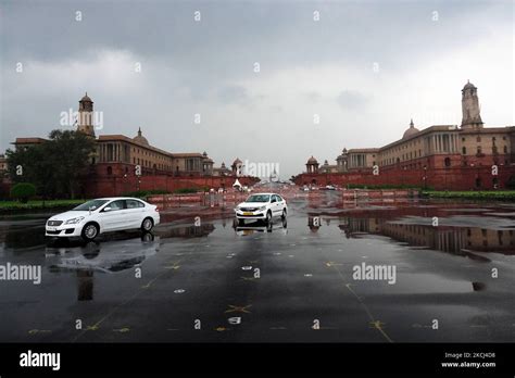 Vehicles move past the Raisina hills during a light spell of rain in ...