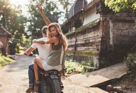 Couple enjoying motorcycle ride on village road stock photo (124046) - YouWorkForThem