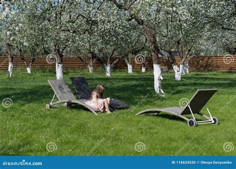 Little Girl Sitting in Blossom Apple Garden. Relaxing Place Stock Photo - Image of green, child ...