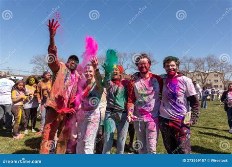 Several People Celebrating the Festival with Colored Powder on Their ...