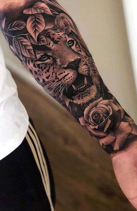 a man's arm with a tiger and roses tattoo on it