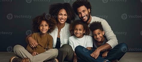 Joyful diverse family sitting on the floor with kids Smiling parents ...