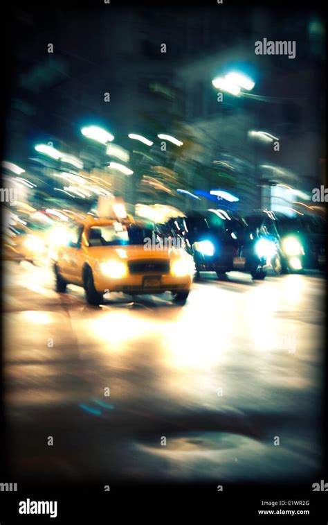 New York yellow taxi on a street at night Stock Photo - Alamy