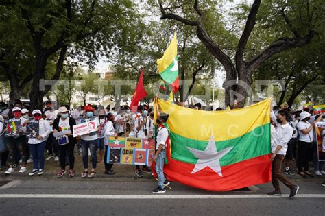 Protesters holding Myanmar big flag - The Shot