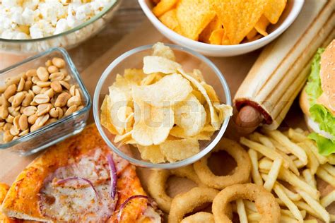 close up of fast food snacks and drink on table | Stock image | Colourbox