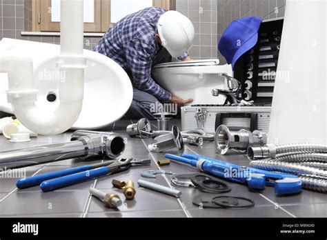 plumber at work in a bathroom, plumbing repair service, assemble and install concept Stock Photo ...