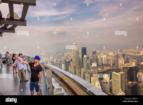 Visitors on top of the Menara KL Tower with view of the Kuala Lumpur skyline Stock Photo - Alamy