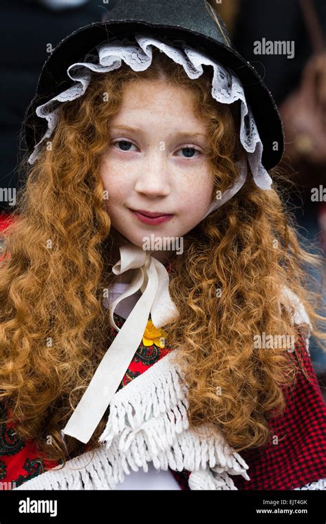 A young girl child with long red ginger hair wearing traditional welsh national costume dress at ...