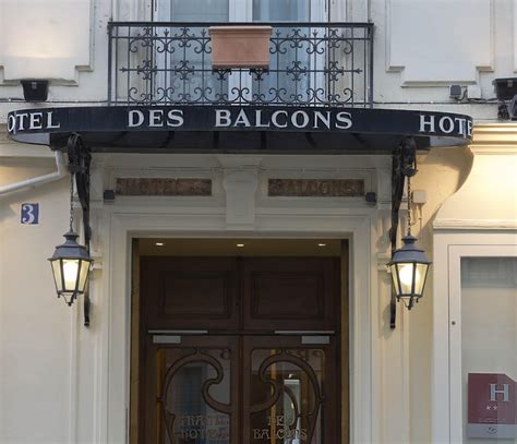 an entrance to a hotel with two lamps on each side and the name des balcons