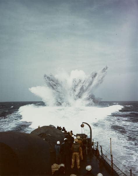 A depth charge explodes in the wake of a U.S. Navy submarine chaser (PC ...