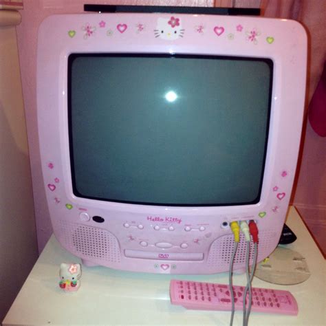 a pink computer monitor sitting on top of a desk