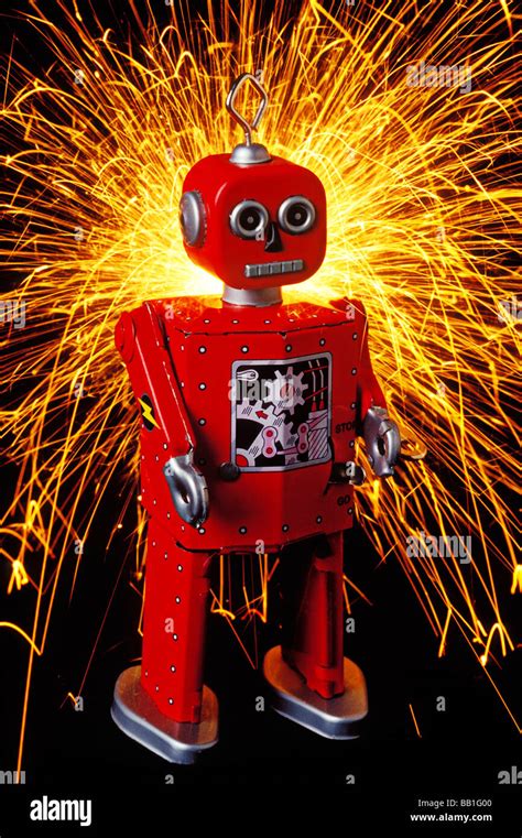 Red toy robot with sparks Stock Photo - Alamy