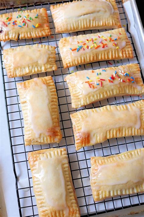 baked pastries with sprinkles are on a cooling rack in the oven