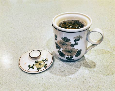 Ceramic Tea Cup with Loose Green Tea Brewing in an Infuser Basket Stock Photo - Image of teacup ...