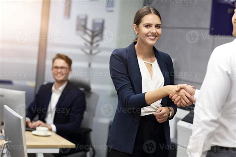 Business people shaking hands in the office 15765004 Stock Photo at Vecteezy