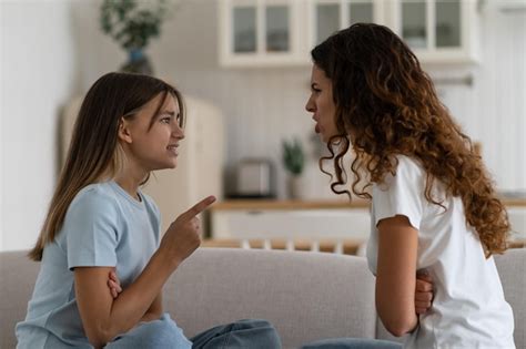 Premium Photo | Emotional teen girl daughter fighting with mother at home sitting in front of ...