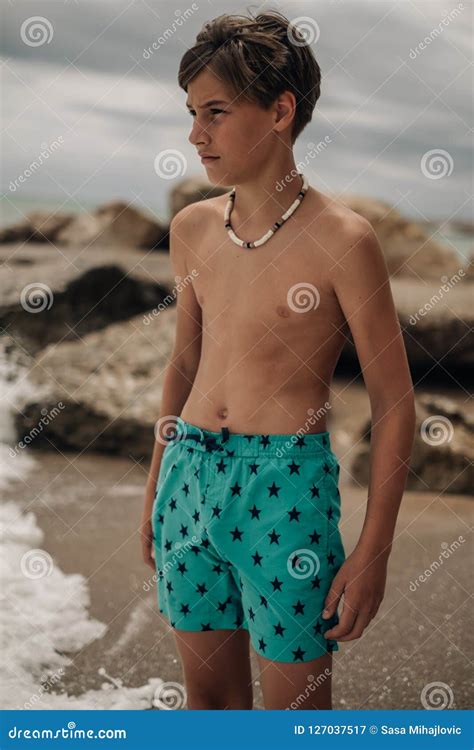 Portrait of a Boy Standing on the Beach with Waves Stock Image - Image ...