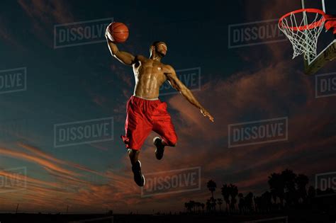 Black man playing basketball - Stock Photo - Dissolve