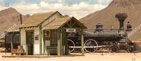 Old West train station and locomotive, a train station with a train on ...