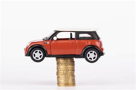Toy car on stack of coins - Creative Commons Bilder