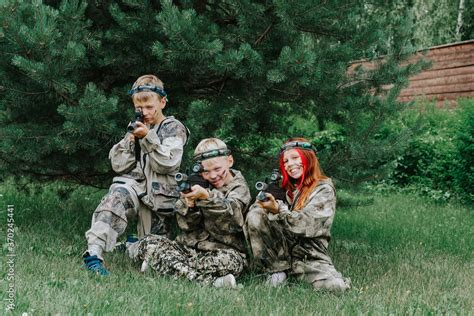 Children playing in lasertag shooting game, boy with a gun, war ...