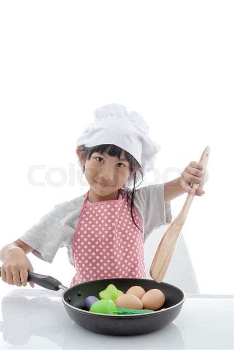 Asian girl cooking at home | Stock image | Colourbox