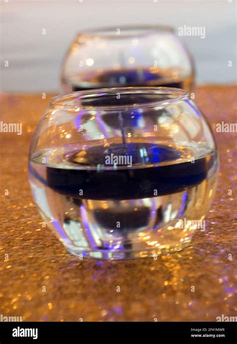 Glass bowls with floating candles Stock Photo - Alamy