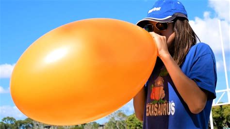 Girl Blowing Up Balloons – Telegraph