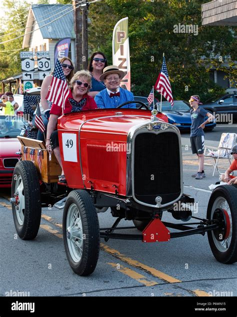 A fancy orange 1931 Ford Model A Doodlebug Tractor driving in the 4th ...