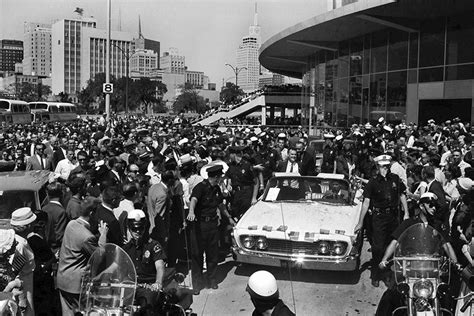 Police clear a path for Kennedy and Johnson as the pair make their way ...