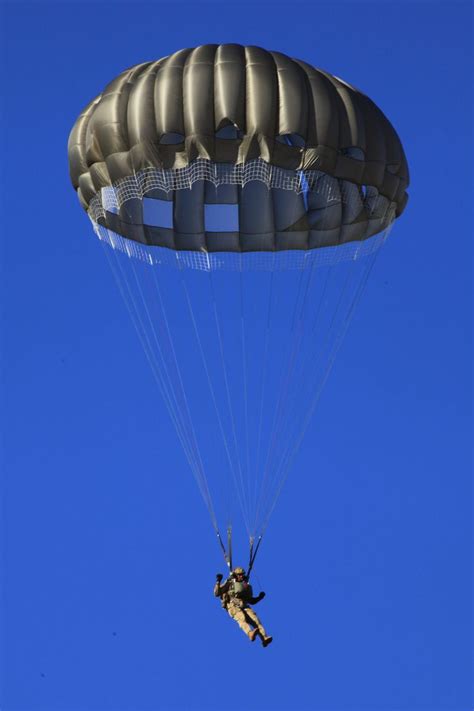 A Combat Controller from No. 4 Squadron parachutes from a C-130J Hercules over the Delamere ...