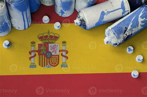 Spain flag and few used aerosol spray cans for graffiti painting. Street art culture concept ...