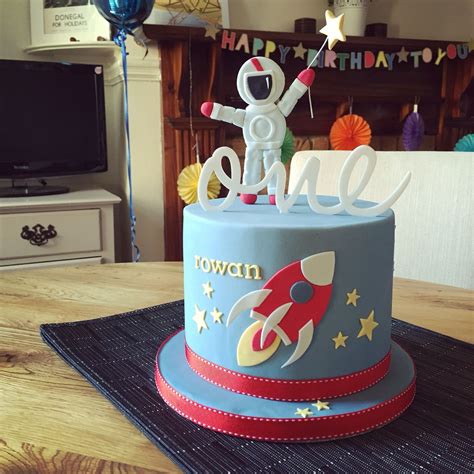 Space themed first birthday cake with stars, astronaut and rocket by Cake Poppins, Newcastle ...