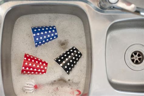 Free Image of Colorful polka dot mugs being washed | Freebie.Photography