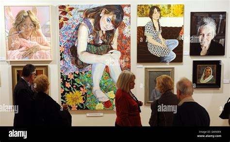 Visitors study the artwork at the Mall Galleries in central London, where the Royal Society of ...