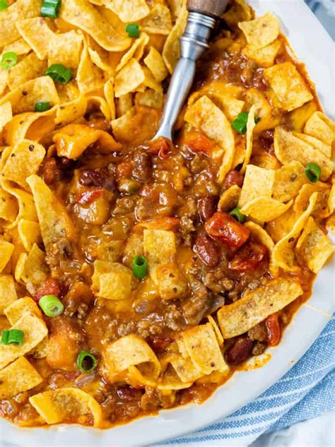 This Frito Pie Recipe has a hearty Beef Chili that's topped with cheese and Fritos and served ...