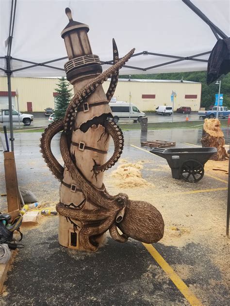 Awesome chainsaw carving of an octopus holding a broken lighthouse together : r/octopus