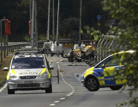 Emergency services and crash investigation officers work at the site ...