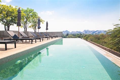 Premium Photo | Landscape of rooftop swimming pool with mountain view on background